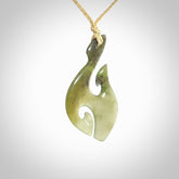 This photo shows a hook with koru pendant carved from New Zealand Jade. We provide this piece with an adjustable oat cord.